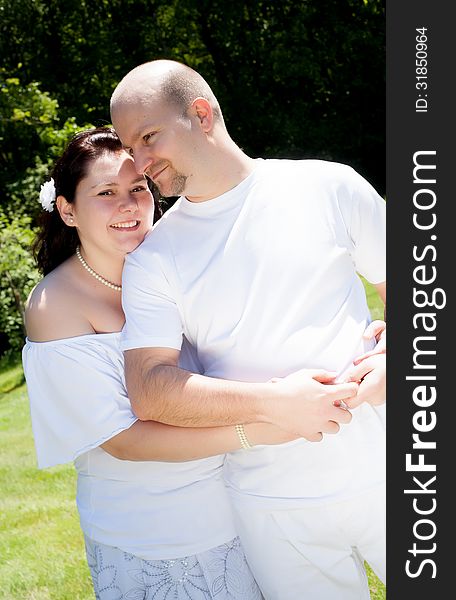 Happy young couple dressed white in the nature. Happy young couple dressed white in the nature