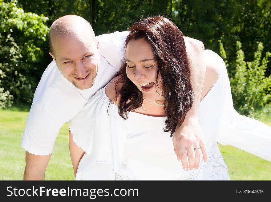 Happy young couple dressed white in the nature. Happy young couple dressed white in the nature