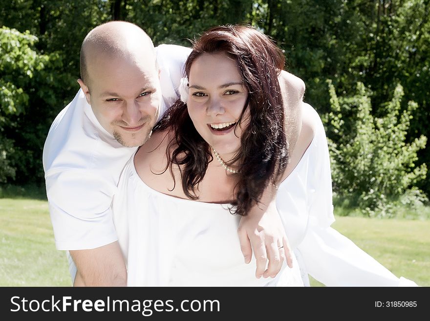 Happy young couple dressed white in the nature. Happy young couple dressed white in the nature