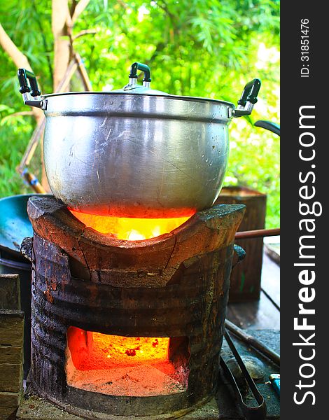 Rice cooker, boiling in the aluminum pot on Stove