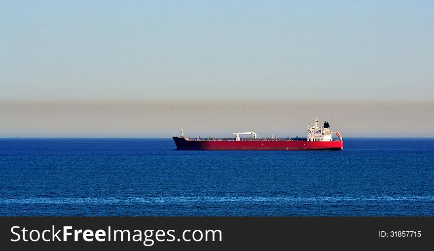 Seascape with cargo ship on blue atlantic ocean