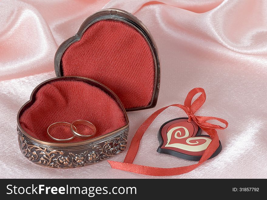 Wedding rings in a metal box with decorative ornament