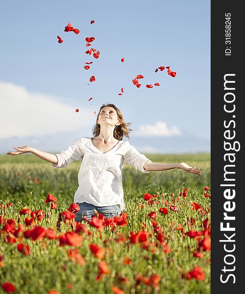 Young casual woman relaxing in poppy field. Young casual woman relaxing in poppy field