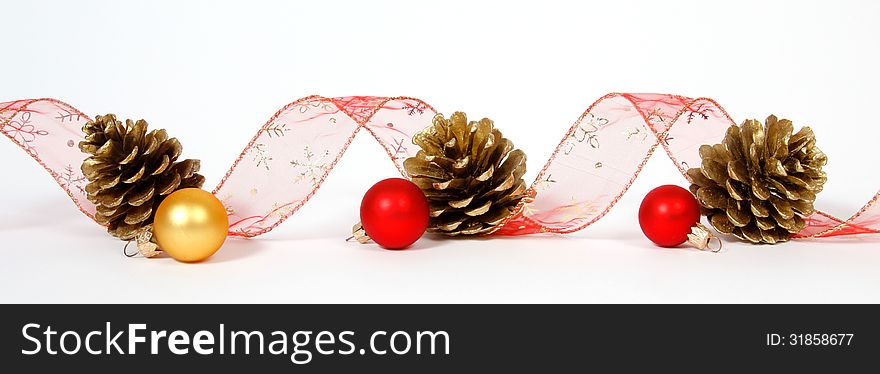 Baubles and cones with the ribbon on the white background. Baubles and cones with the ribbon on the white background