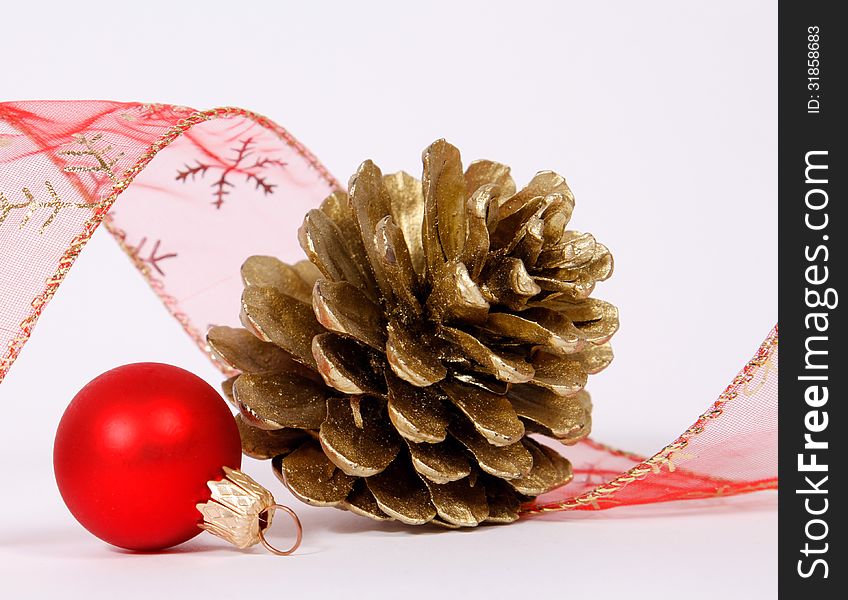 Bauble and cone with the ribbon on the white background. Bauble and cone with the ribbon on the white background