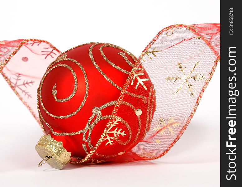 Red-golden bauble with the ribbon on the white background. Red-golden bauble with the ribbon on the white background