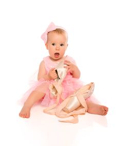 Little Baby Girl In A Pink Ballerina Dress With Pointe Shoes Stock Photo