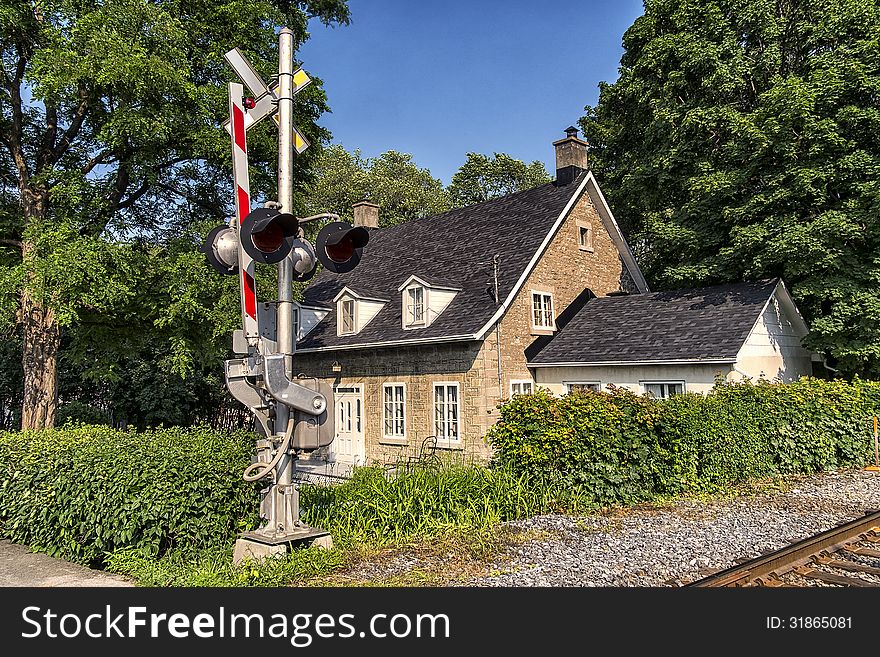 House at the railway crossing on a nice afternoon