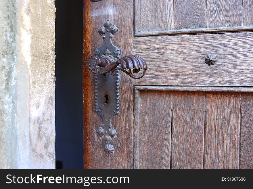 Historical door detail with metal latch. Historical door detail with metal latch.