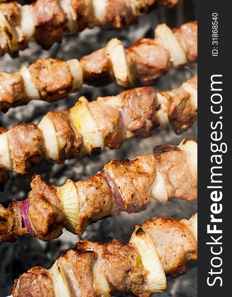 Cooking delicious shish kebab on outdoors grill