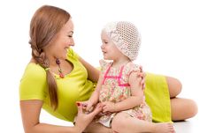 Happy Mother And Little Girl Lying On Floor And Smiling Royalty Free Stock Photos