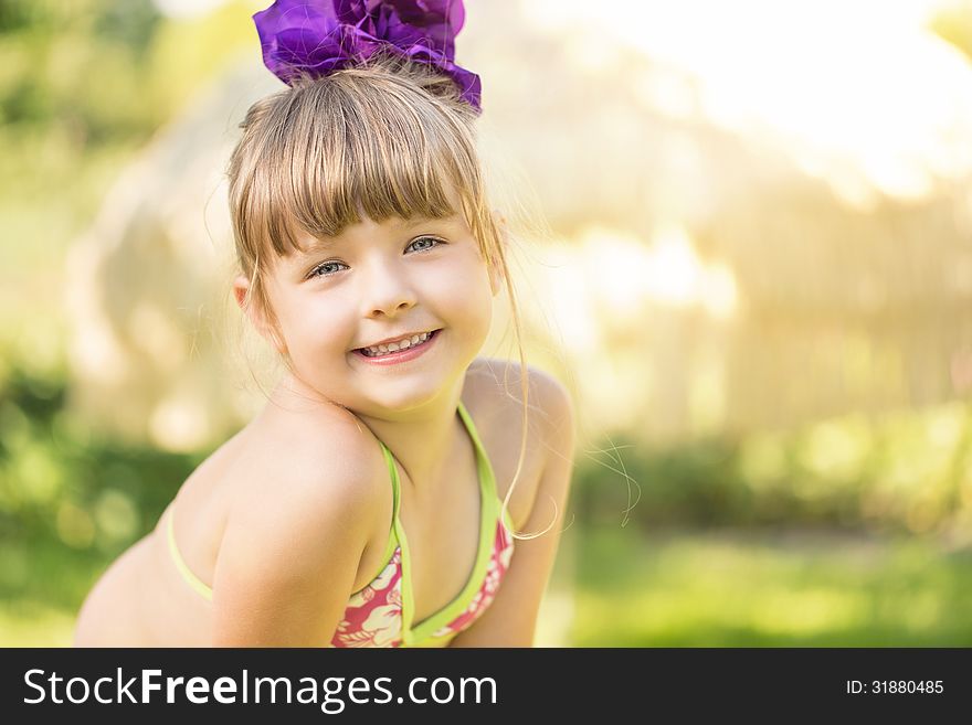 Portrait of a cute little girl on summer vacations with copy space