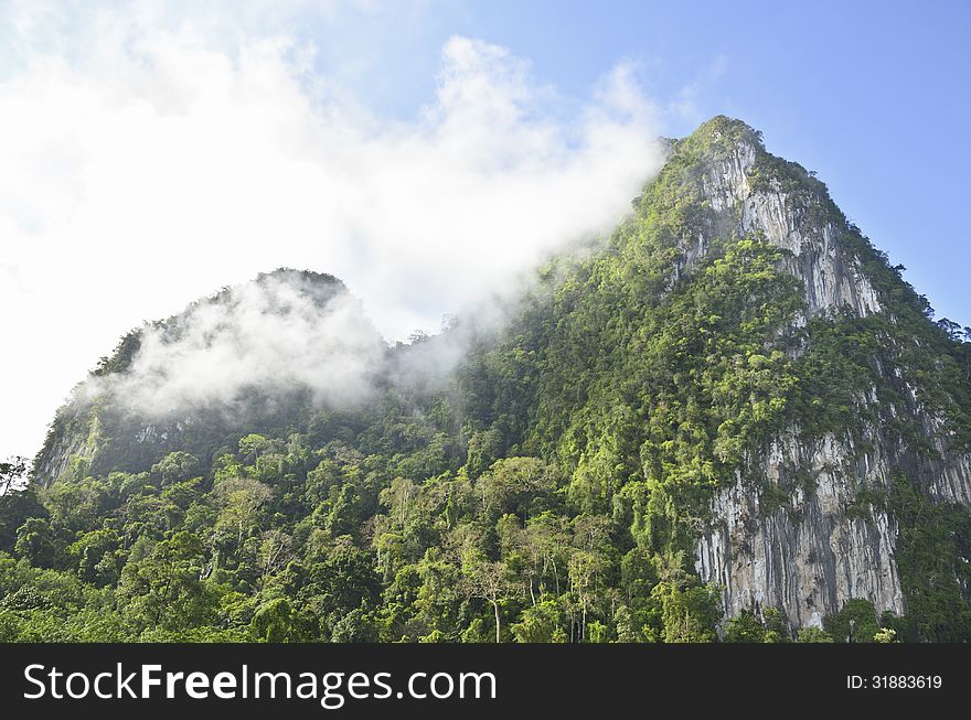 Limestone mountain surrounded by tropical forests of Thailand. Limestone mountain surrounded by tropical forests of Thailand.