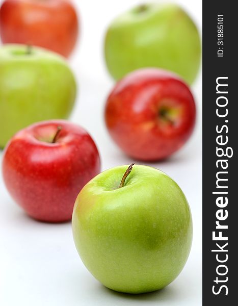 Delicious red and green apples on a white background