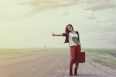 Girl Standing On Road With Suitcase Looks For Fellow Traveler Royalty Free Stock Photography