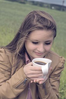 Girl Drinks Coffee With Pleasure Outdoors Royalty Free Stock Photo