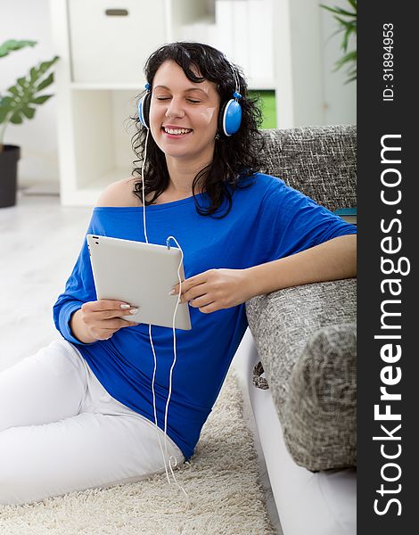 Young modern woman  with electronic tablet and headphones. Young modern woman  with electronic tablet and headphones