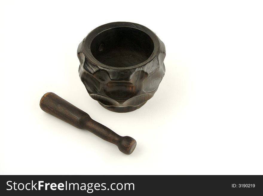 Wood mortar and pestle on a white background.