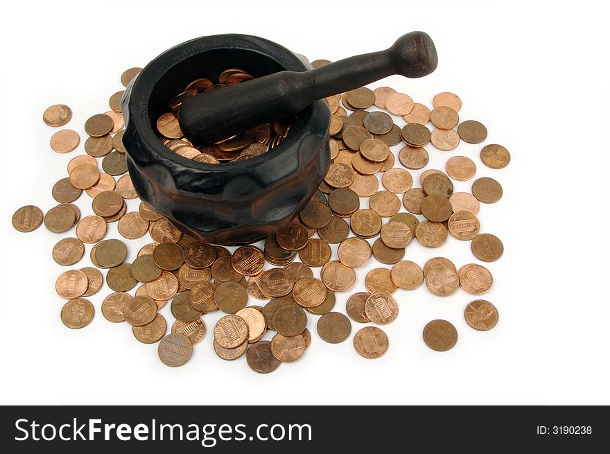Grinding for Pennies - Wood mortar and pestle containing pennies on a white background.