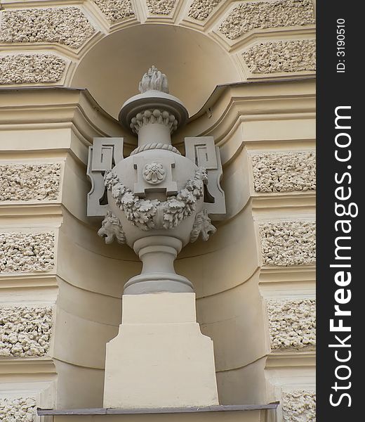 The beautiful stone vase decorated by patterns from colors. On a stone pedestal in the form of a cube. The beautiful stone vase decorated by patterns from colors. On a stone pedestal in the form of a cube.