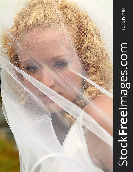 Close up of bride with her veil on. Close up of bride with her veil on.