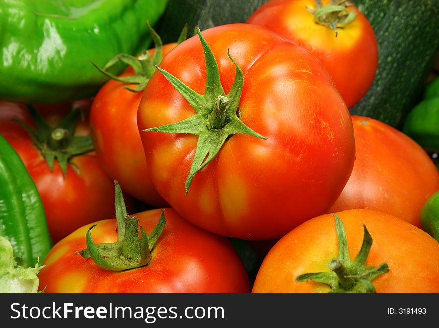 Organically grown red tomatoes and green peppers. Organically grown red tomatoes and green peppers