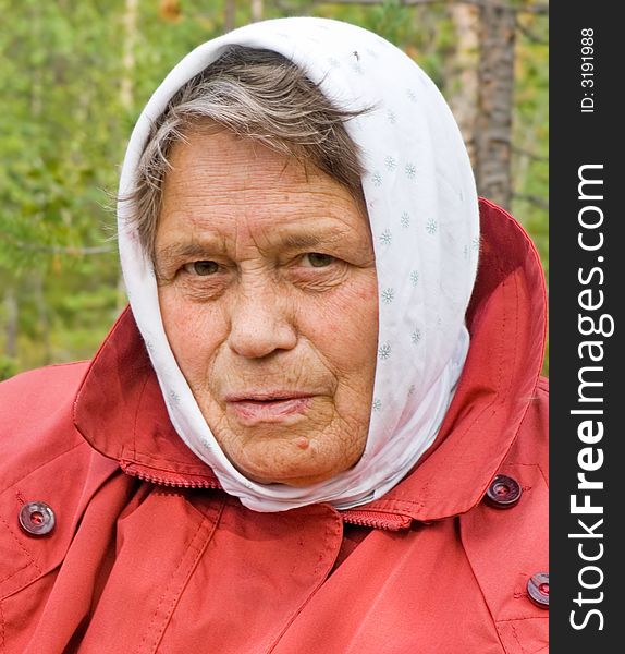 The elderly woman in a scarf. The elderly woman in a scarf