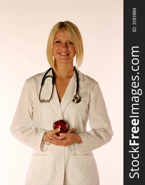 Female doctor holding an apple