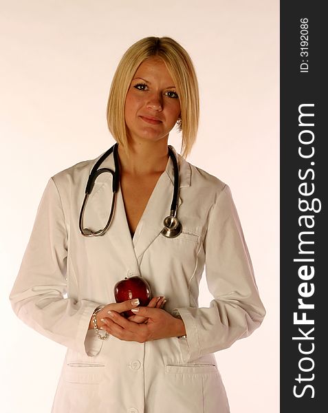 Female doctor holding an apple