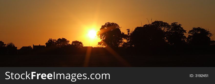 Sunset over fields and trees in UK. Sunset over fields and trees in UK