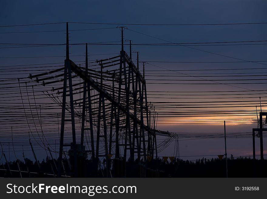 Electricity pylons with several cables. Silhouettes at dawn. Electricity pylons with several cables. Silhouettes at dawn.