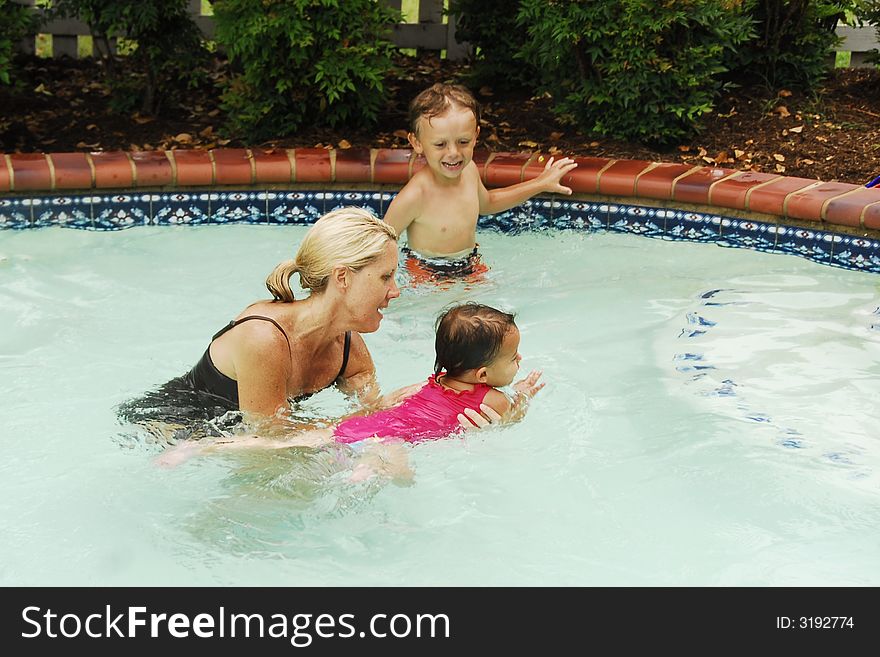 A baby girl at swimming lessons.