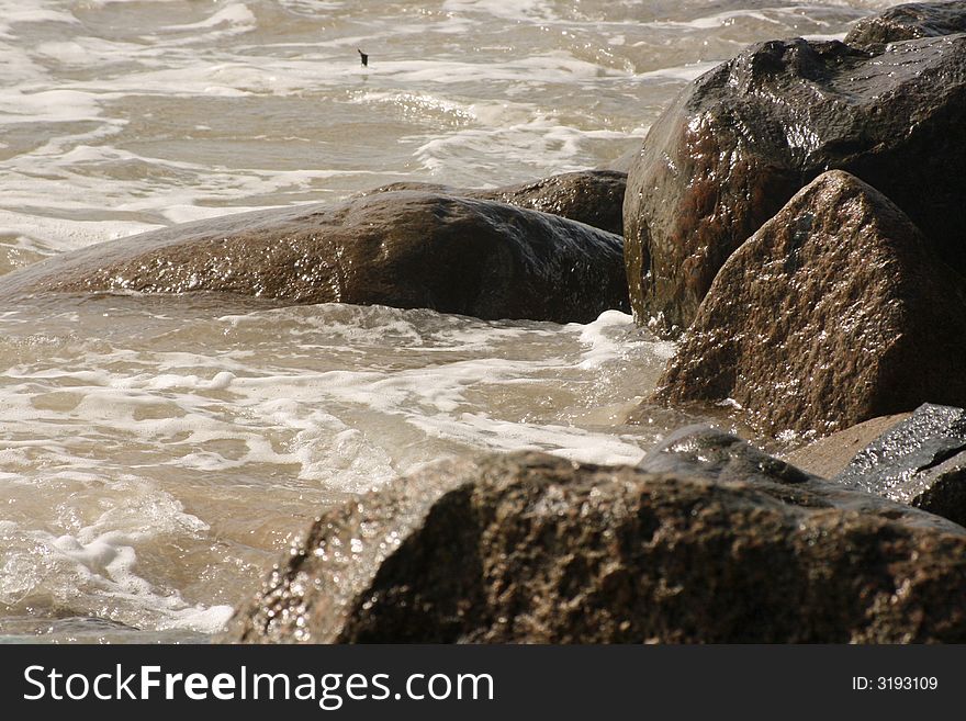 Ocean waves crashing to shore along coastline