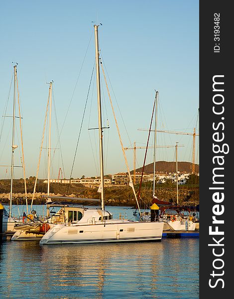 Yacht moored against a jetty in a marina. Yacht moored against a jetty in a marina