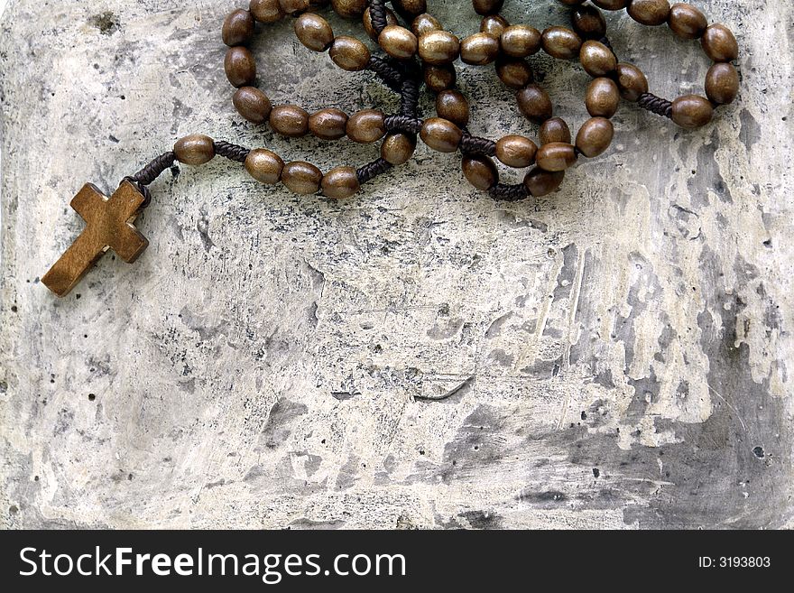 A rosary on a stone background
