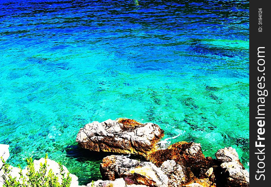 Azure sea water & stony coast. Azure sea water & stony coast