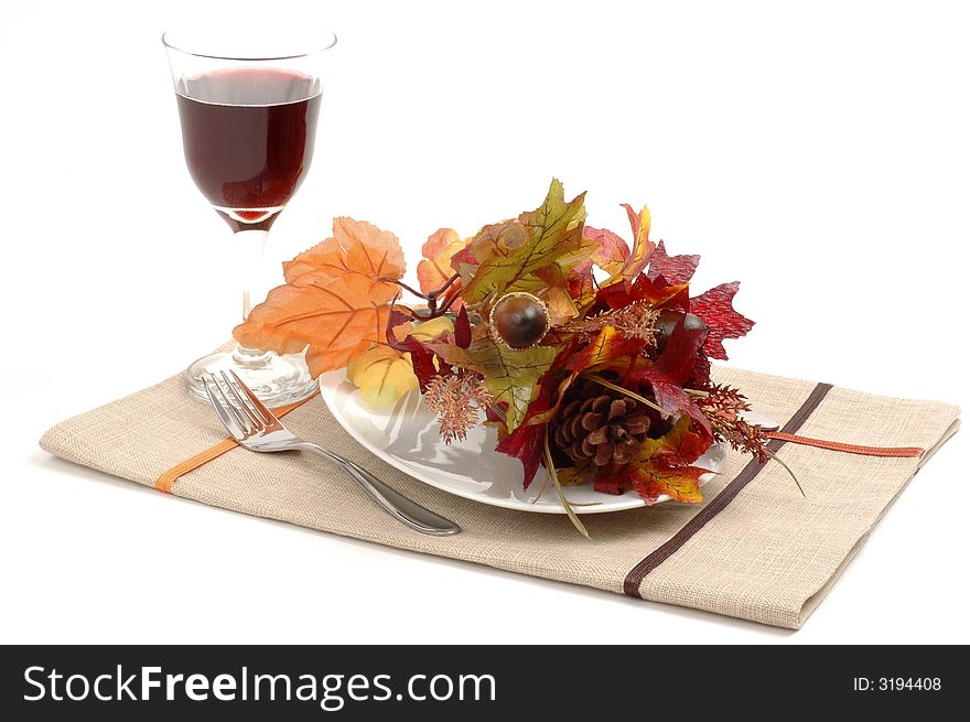 Colorful dried autumn leaves make up this table setting. Colorful dried autumn leaves make up this table setting.