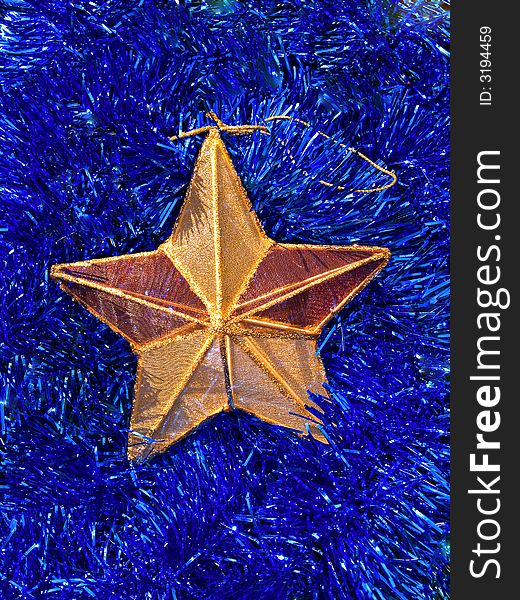 Christmas decoration - star on a bright blue background. Christmas decoration - star on a bright blue background