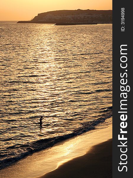 Young woman relaxing in the sea at golden sunset. Young woman relaxing in the sea at golden sunset