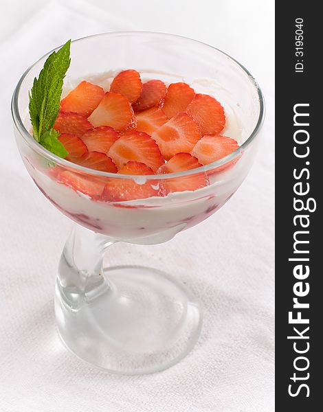 Ice-cream with strawberry in glass vase