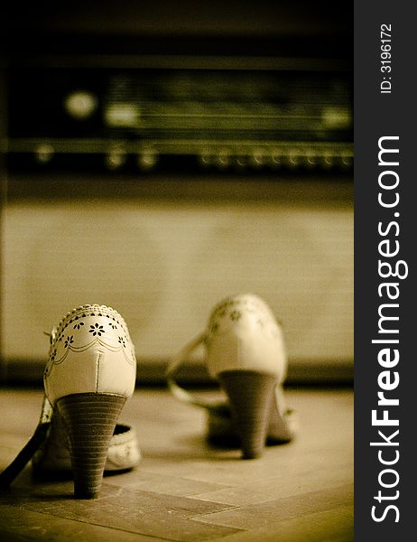 Shoes with an old radio in the background. Shoes with an old radio in the background