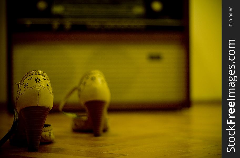 Shoes with an old radio in the background. Shoes with an old radio in the background