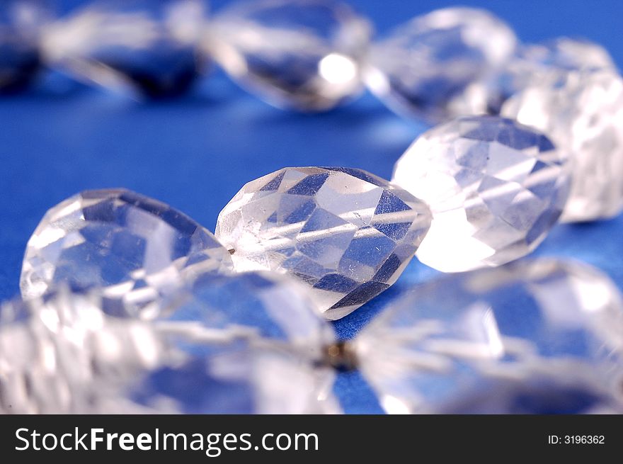 Photo of shining necklace on the blue background