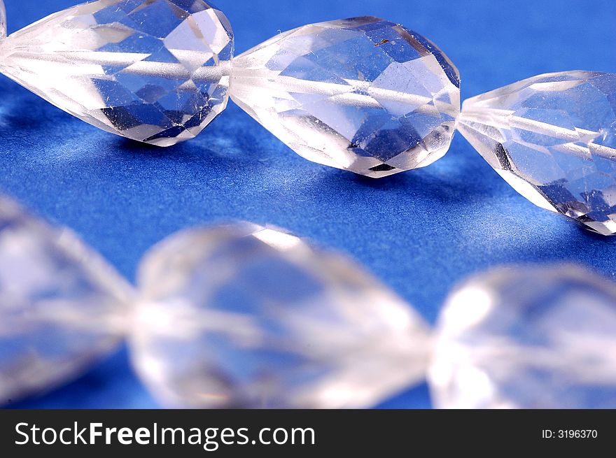 Photo of shining necklace on the blue background