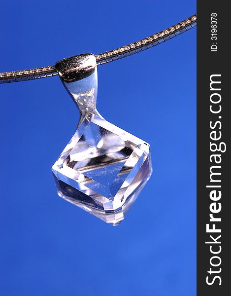 Photo of shining necklace on the blue background