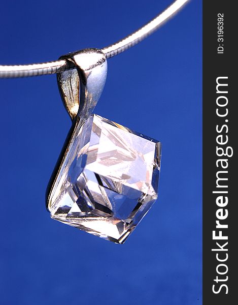 Photo of shining necklace on the blue background