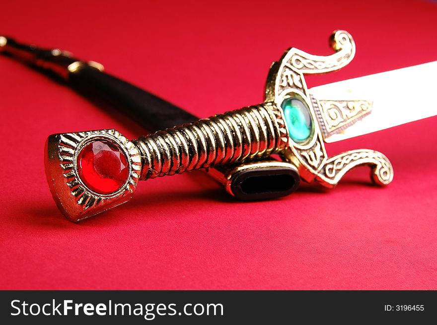 Photo of ornamental knife on the red background