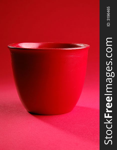 Photo of red vessel isolated on the red background