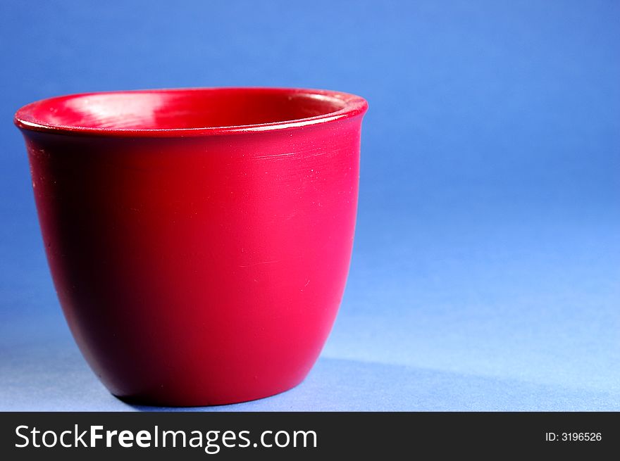 Photo of red vessel isolated on the blue background