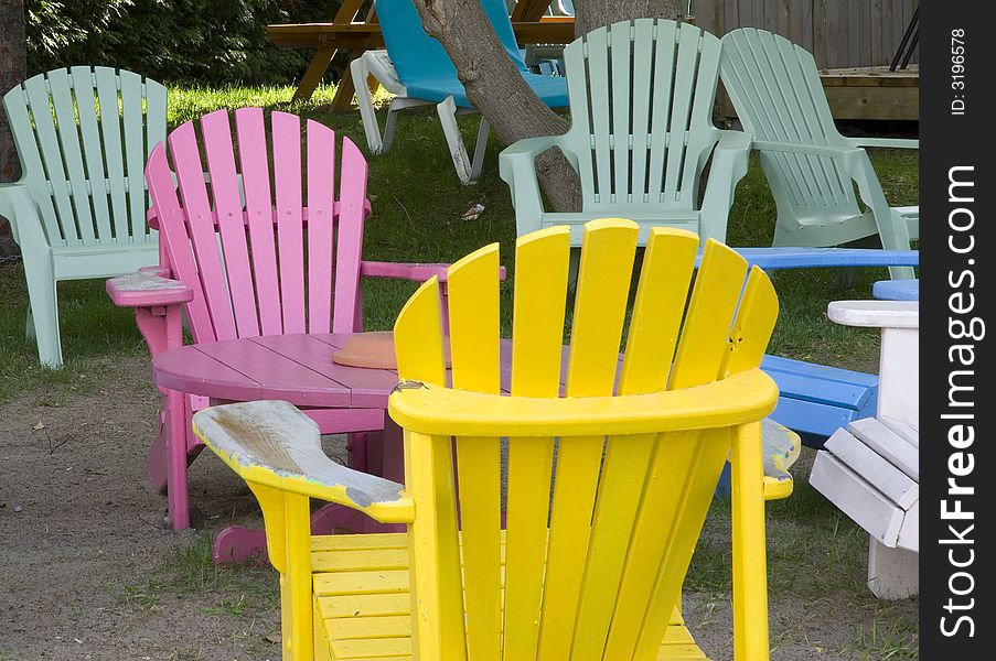 Multi coloured wooden deck chairs in outdoor cafe